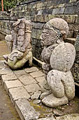 Candi Cetho - Guardians standing on the ninth terrace at the base of the staircase leading to the tenth terrace.